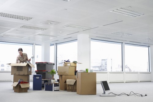 Workers coordinating safe movement of furniture inside a property